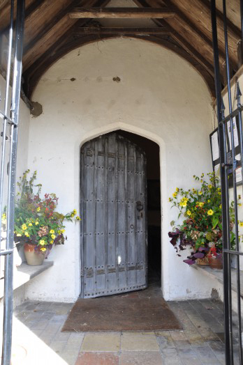 The sixteenth century south door inside the 19th century porch at Liston church