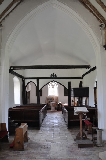 The 15th century font with its battlemented rim