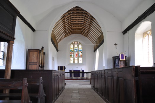 Inside Belchamp Otten church, note the doors on the ends of the pews