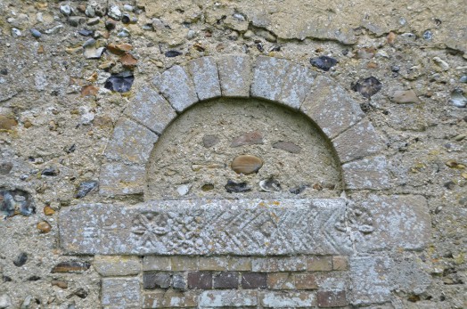 Carved detail on a bricked up doorway at Liston Church
