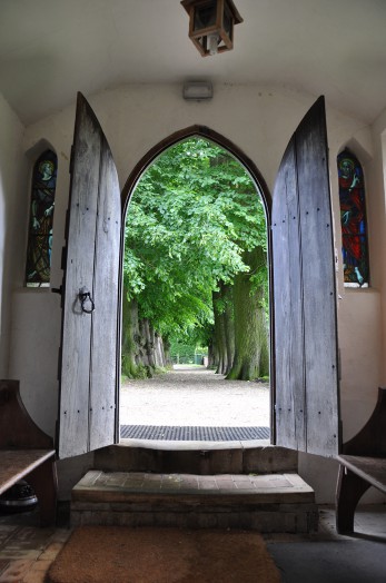 Looking throught the door out into the churchyard at Bulmer