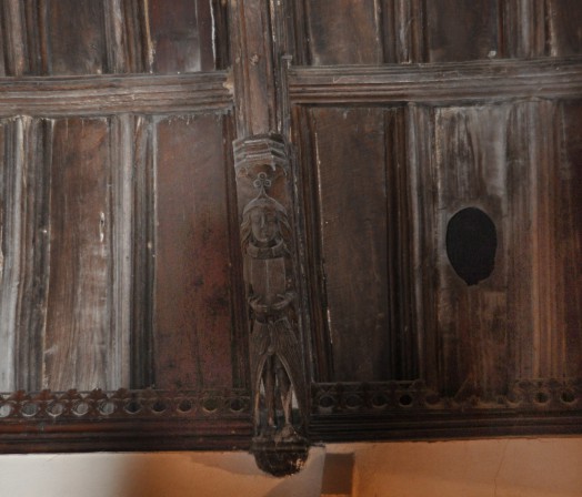 A carved figure in the chancel ceiling