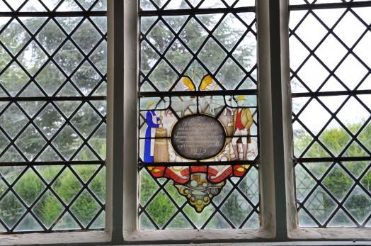 An unusually contemporary stained glass window in memorial to members of a local farming family