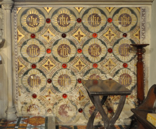 East wall decoration featuring red glass bosses at Liston church