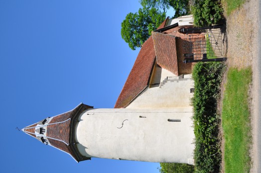 The distinctive round tower of Lamarsh church viewed from the road