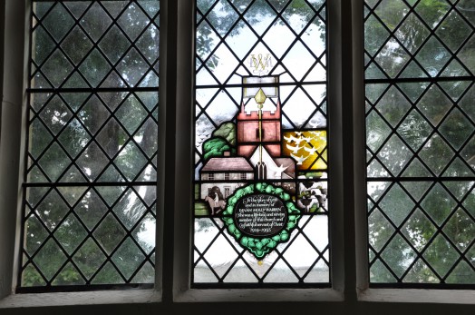 A memorial window dedicated to former church warden Dinah Warren, depicting the church tower, one of the oldest houses in the village and Dinah mounted on her horse.