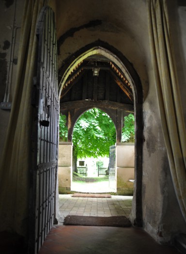 View from inside Alphamstone church into the churchyard
