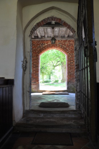 A view from within the church to the churchyard at Lamarsh